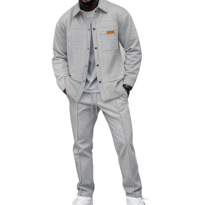 Model wearing the set in light grey, shirt worn open-buttoned over a grey tee with white trainers 2