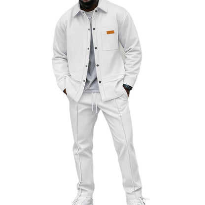 Model wearing the set in white, buttoned shirt over a grey tee and matching trousers 4