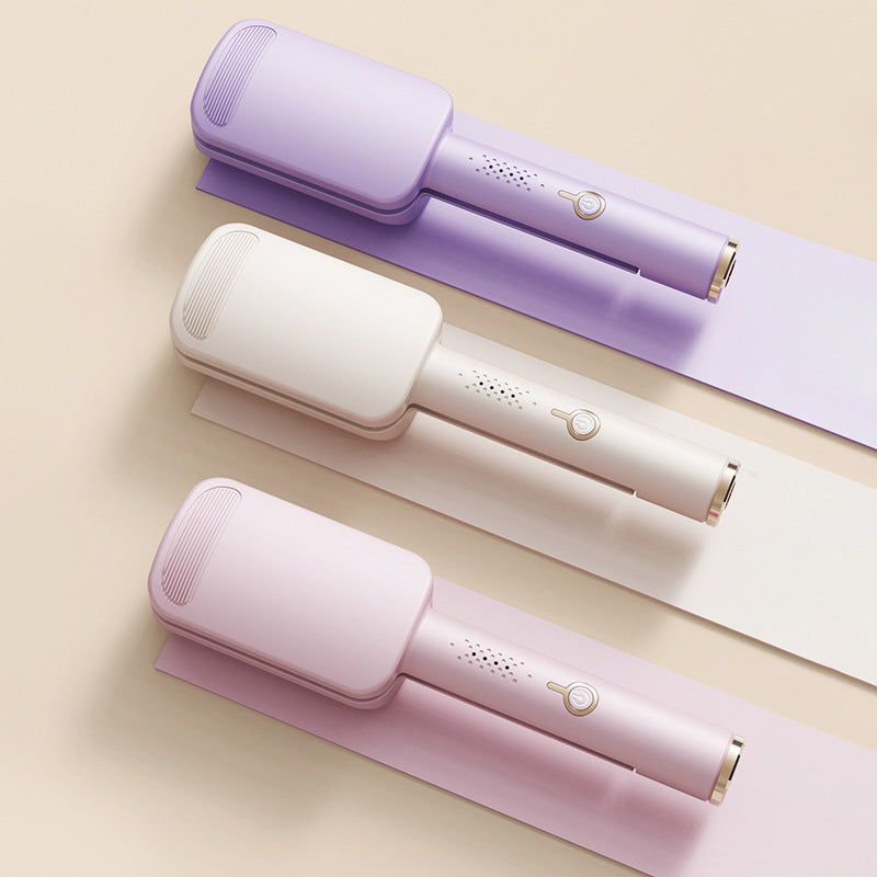 Flat lay of three wave irons in purple, cream and pink, seen from above 2