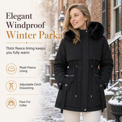 Smiling woman in a black hooded parka with drawstring waist, standing on a snowy brick street 1