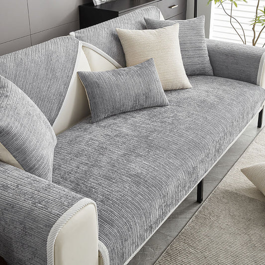 Grey ribbed chenille cover on a cream sofa, styled with grey and cream cushions beside a plant. 1