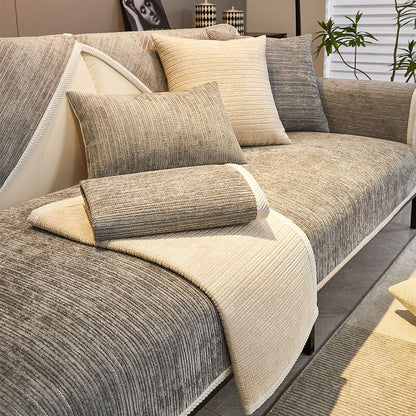 Grey chenille covers with a cream cover folded over the seat and a rolled cushion, shown on a sofa. 12