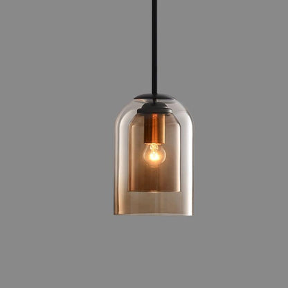 Single amber glass pendant light with an inner shade and copper-toned socket, lit, on a plain grey background 11
