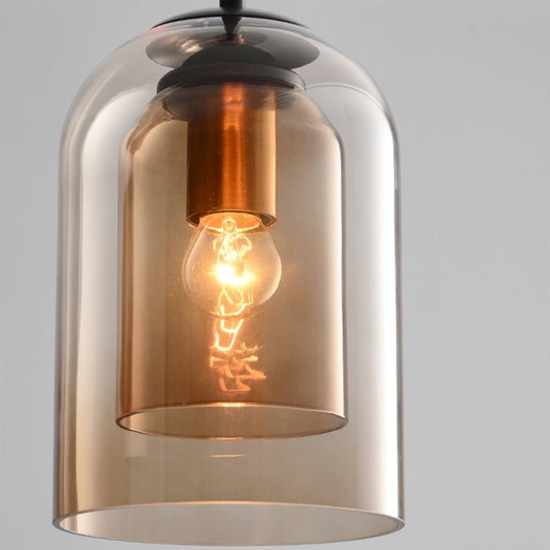 Close-up of the amber double glass shade, showing the inner shade, copper-toned socket and glowing bulb 9
