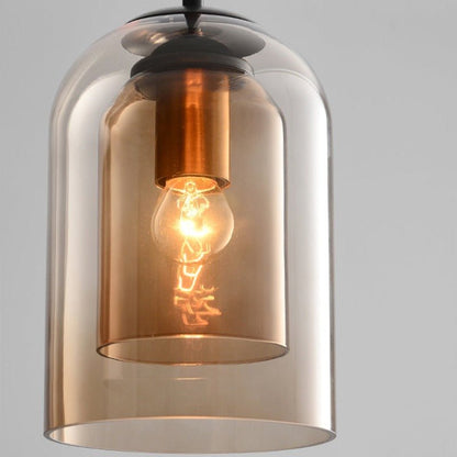 Close-up of the amber double glass shades with a copper-toned bulb holder and lit bulb 9