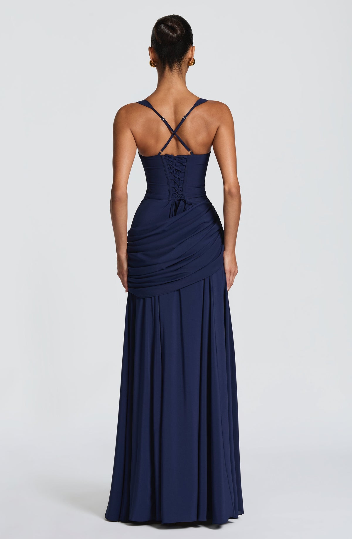 Back view of the navy dress, showing the lace-up corset back, crossed adjustable straps and draped hip panel. 9