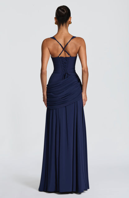 Back view of the navy dress, showing the lace-up corset back, crossed adjustable straps and draped hip panel. 9