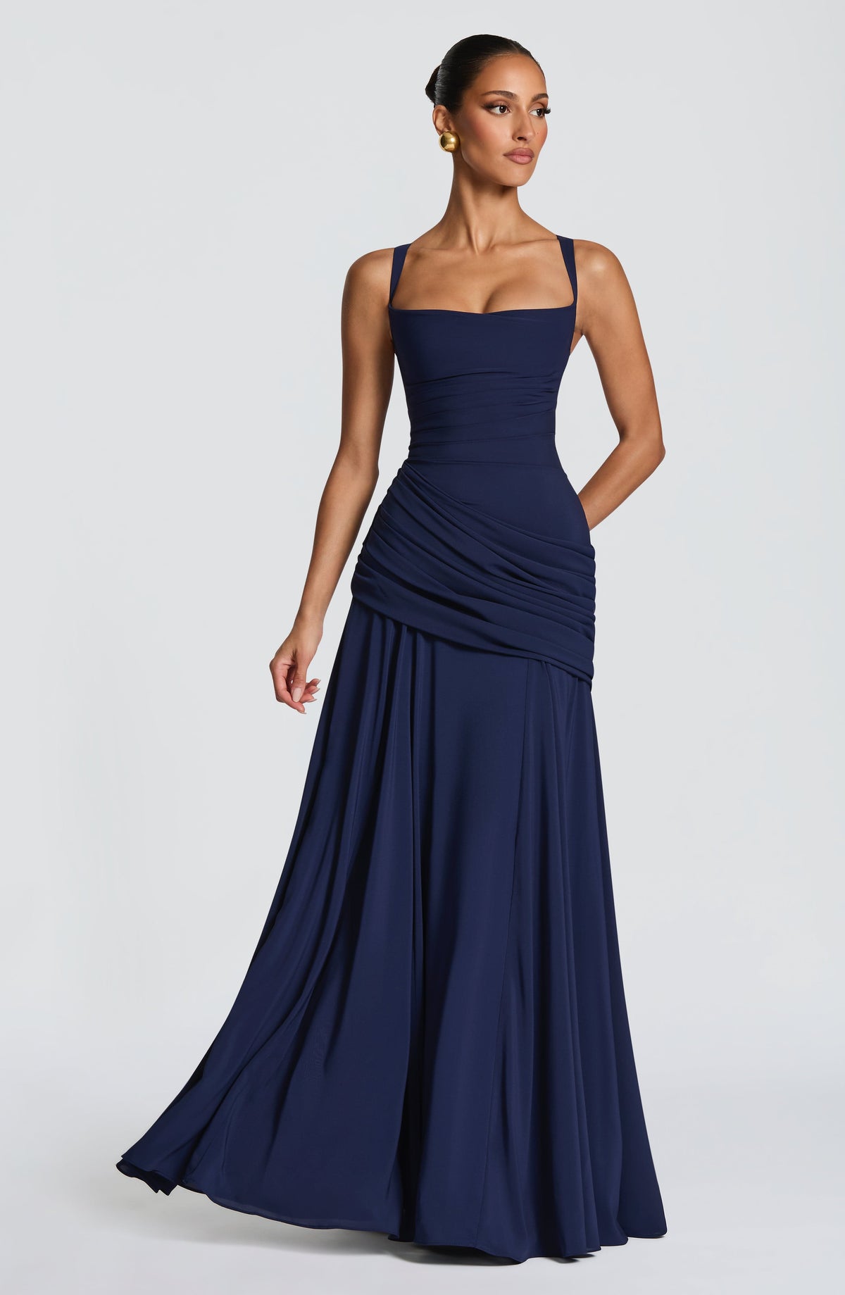 Navy dress on a model turned slightly, with one hand behind her, showing the swirling chiffon skirt. 6