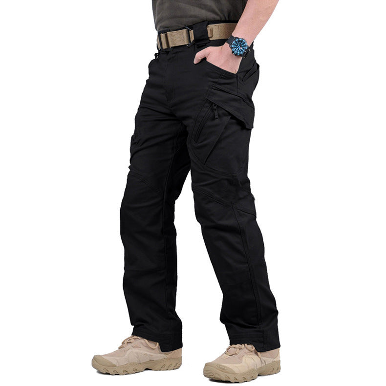 Side view of the trousers in black, worn with a tan belt and desert boots 5