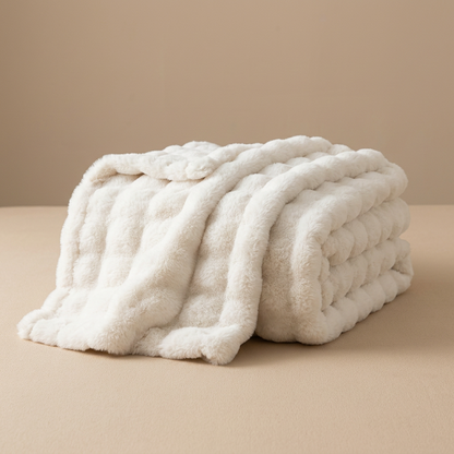 Cream white fluffy blanket folded in a stack, shown on a beige surface 16
