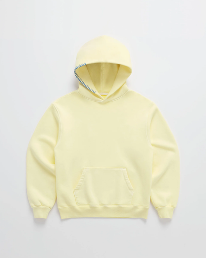 Flat lay of the pale yellow hoodie with a kangaroo pocket, ribbed cuffs and contrasting blue stitching along the hood edge. 1