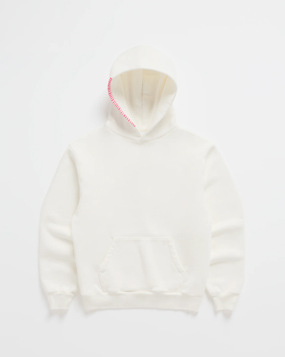Flat lay of the cream hoodie with a kangaroo pocket and bright pink stitching running along one edge of the hood. 2