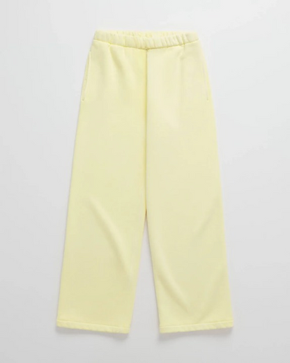 Flat lay of pale yellow loose-fitting joggers with an elasticated waistband and side pockets, matching the hoodie. 6