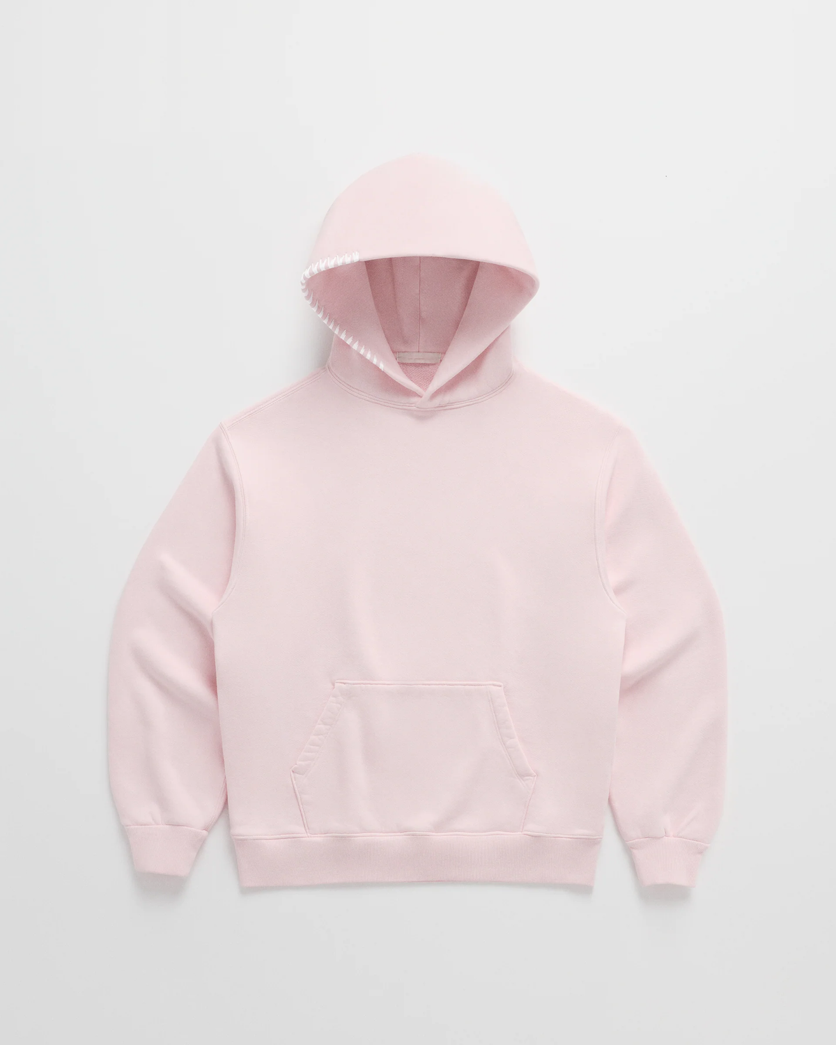 Flat lay of the soft pink hoodie with a front pocket, ribbed hem and white stitching along the hood opening. 3