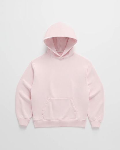 Flat lay of the soft pink hoodie with a front pocket, ribbed hem and white stitching along the hood opening. 3