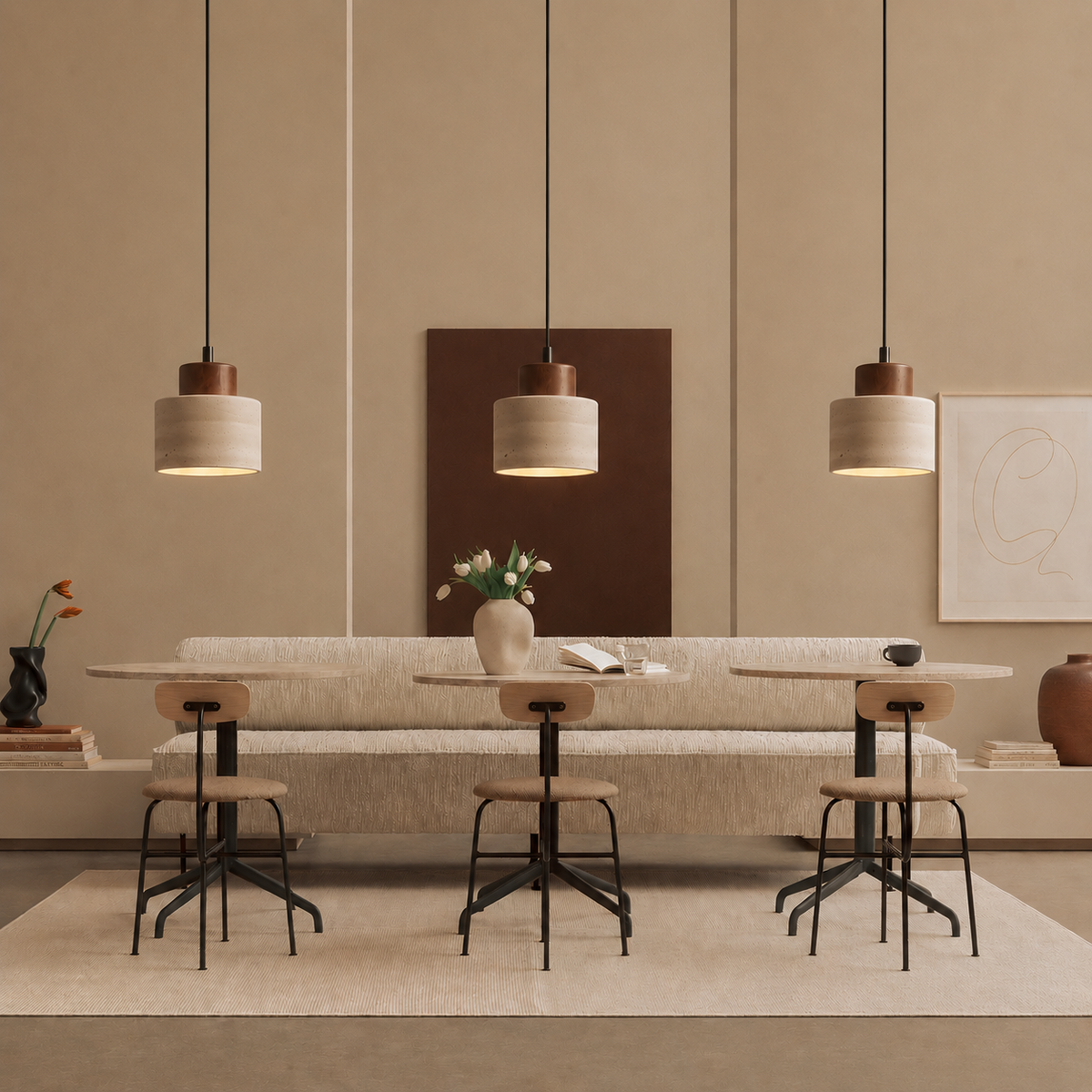 Row of three pendant lights above café-style tables and chairs in a warm neutral dining space 3