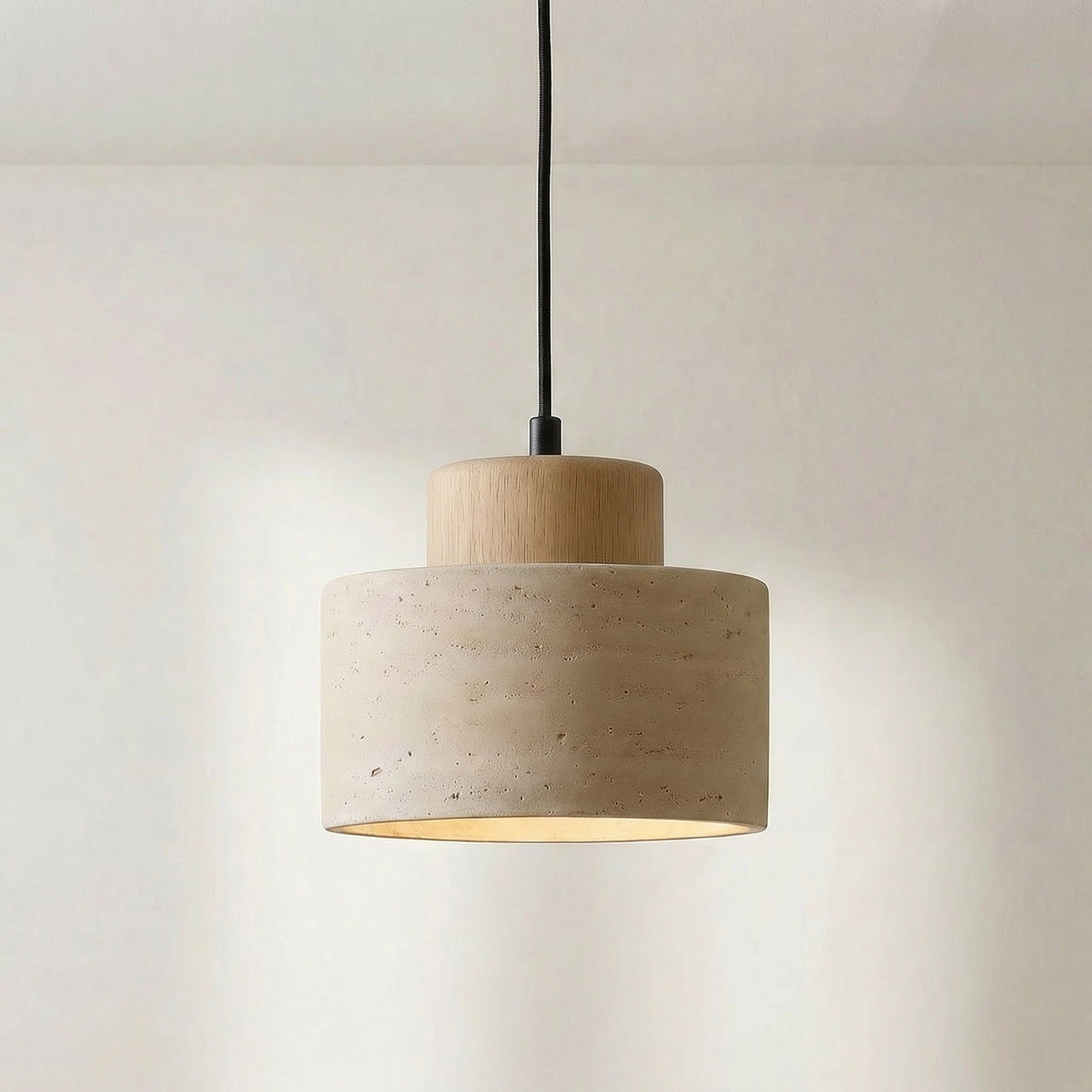 Close-up of the travertine shade with a lighter natural wood cap and black cord 7