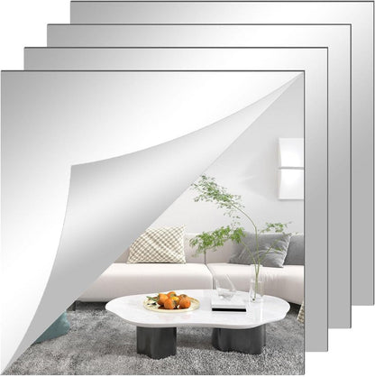 Four square mirror sheets stacked and offset, the front one peeling at the corner to reflect a sofa and coffee table. 3