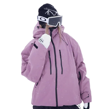 Model in the pink-purple jacket with hood up, one white glove raised near the chin, showing chest zip pockets and sleeve cuff. 2