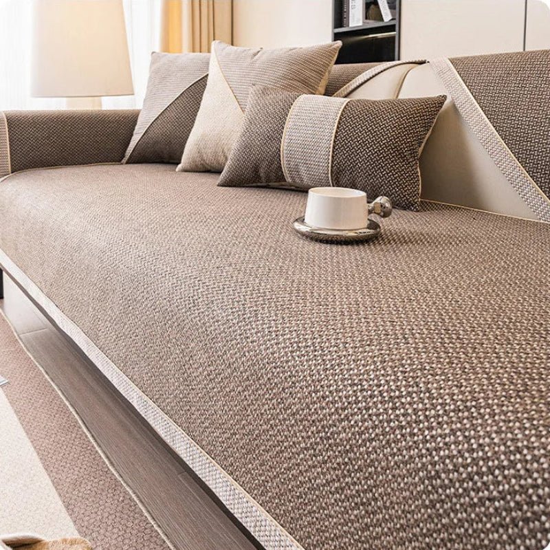 Brown woven sofa cover with pale braided edging, shown with matching brown and beige cushions. 10