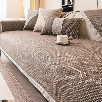 Brown woven sofa cover with pale braided edging, shown with matching brown and beige cushions. 10
