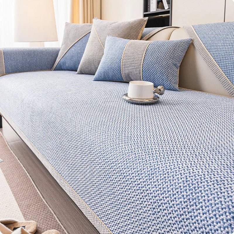Light blue woven sofa cover with braided trim, styled with blue and grey cushions and a white cup. 11