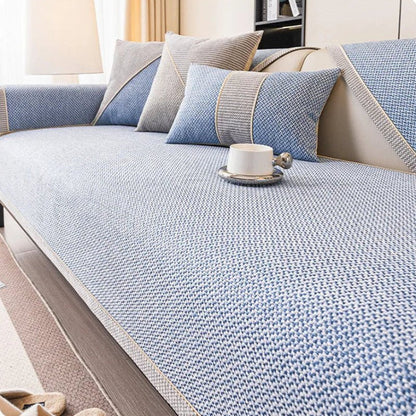 Light blue woven sofa cover with braided trim, styled with blue and grey cushions and a white cup. 11