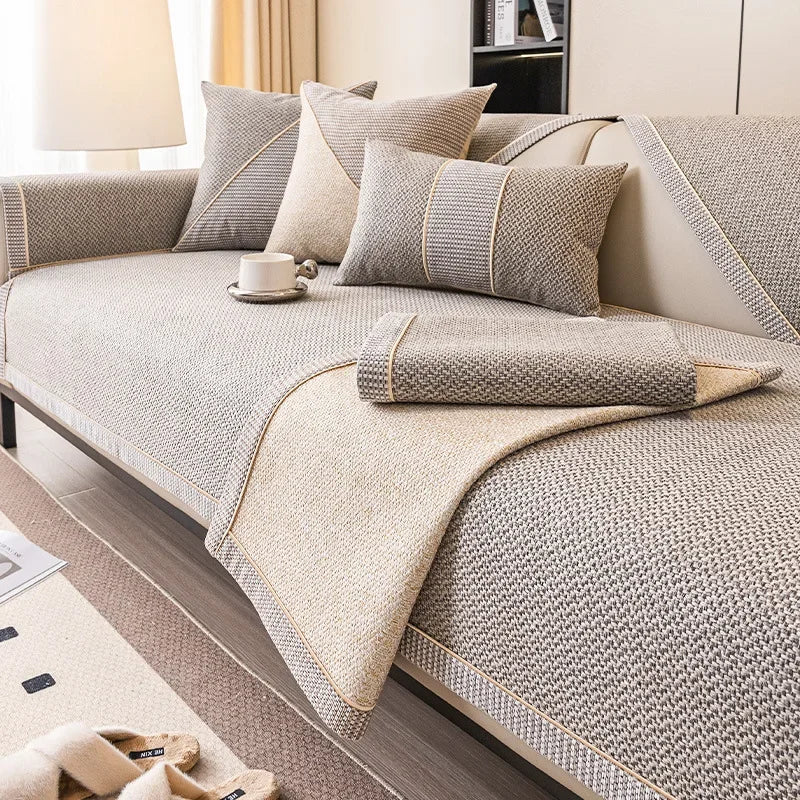 Beige and grey woven cover with one corner folded back, showing the lighter reverse side and braided trim. 4