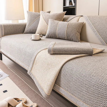 Beige and grey woven cover with one corner folded back, showing the lighter reverse side and braided trim. 4
