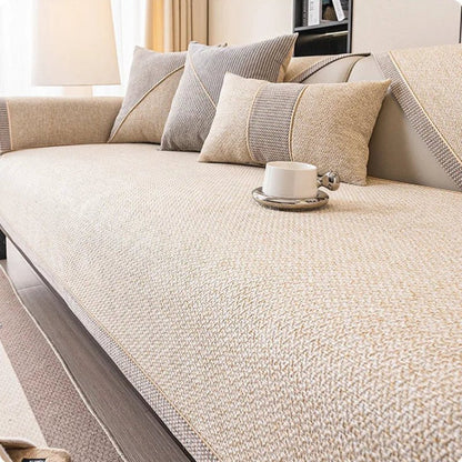 Light cream-beige woven sofa cover with braided trim, styled with grey and beige cushions and a white cup. 9