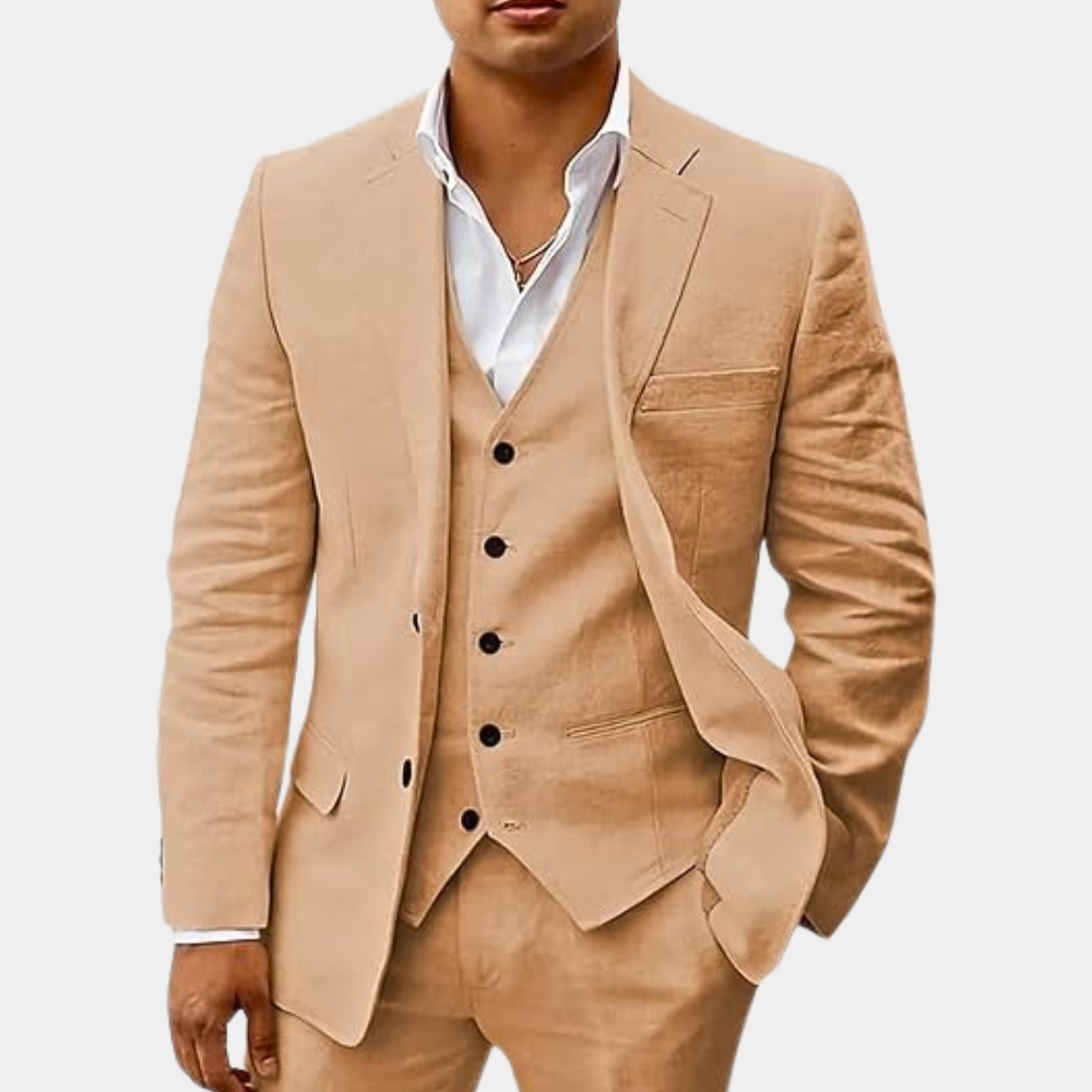 Model wearing the suit in a light tan shade, jacket open over the five-button vest, hand in pocket. 3