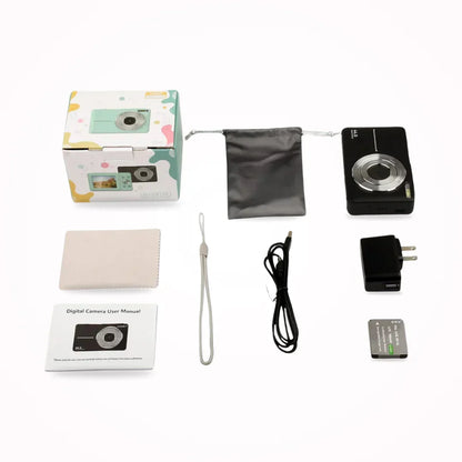 Flat lay of a black camera with its box, pouch, cloth, wrist strap, cable, charger, battery and manual 8
