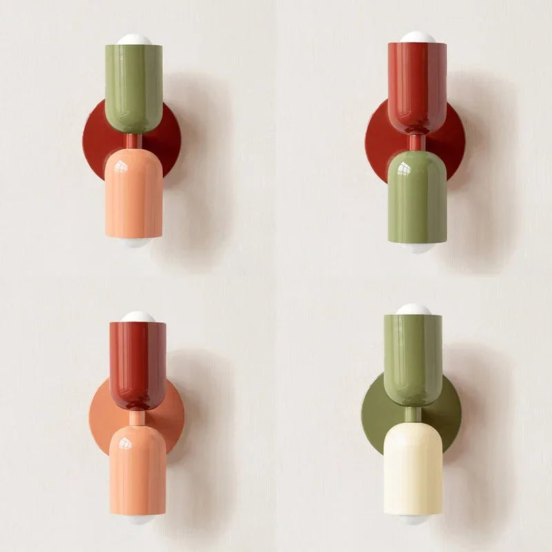 Four versions of the two-tone wall lamp in different colour pairings, including green, red, peach and cream, arranged in a grid. 12