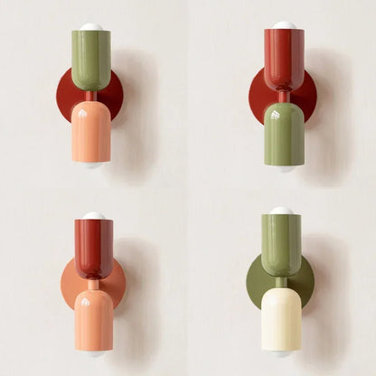 Four versions of the two-tone wall lamp in different colour pairings, including green, red, peach and cream, arranged in a grid. 12