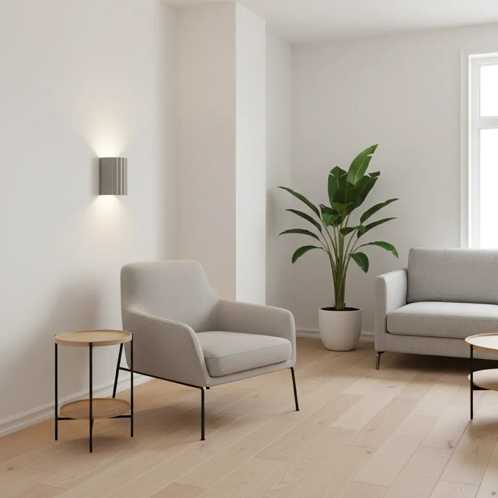 Grey fluted wall light beside an armchair and a tall plant in a light living room 5