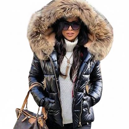 Cut-out of a model in the black padded jacket with a big brown fur hood, sunglasses, white jumper and brown handbag. 8
