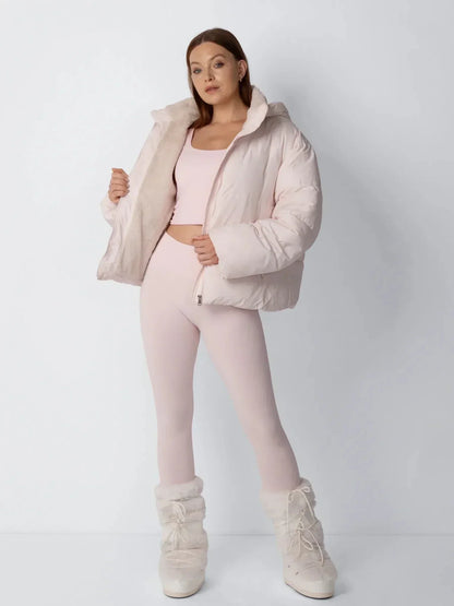 Full-length view of the pale pink puffer jacket held open to show the fleece lining, worn with white fluffy boots 8