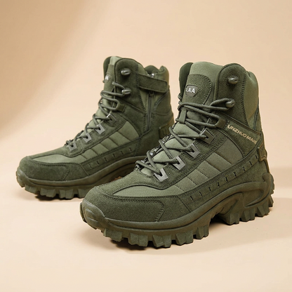 Pair of olive green lace-up boots on a peach background, with a side zip visible on one 25