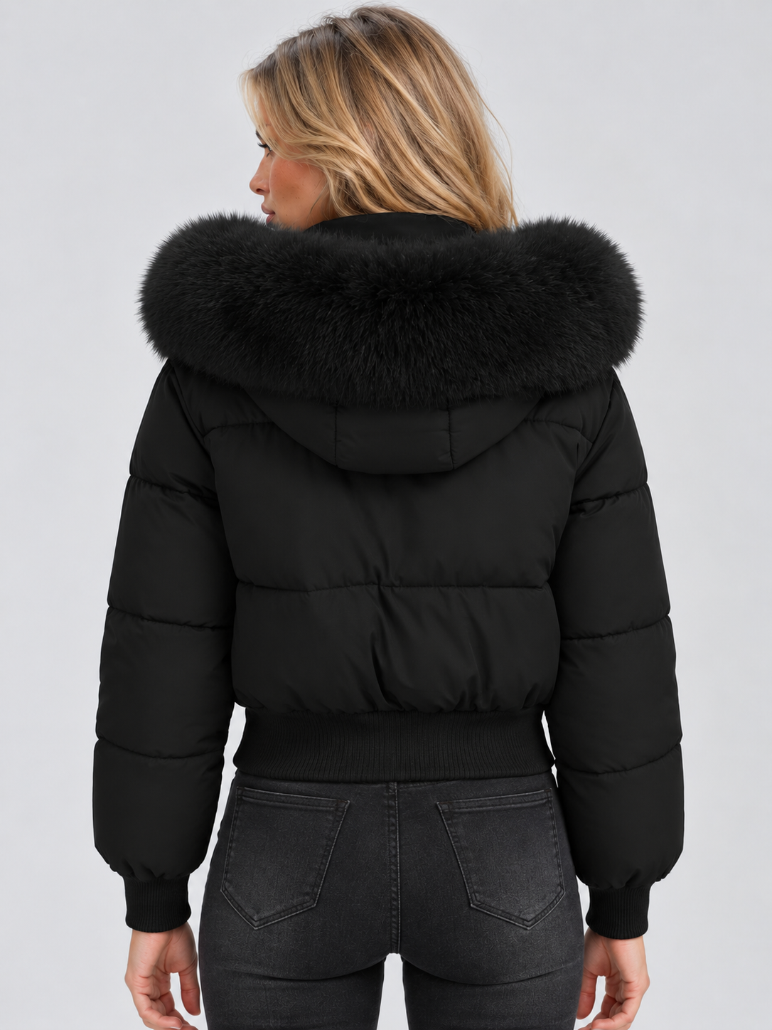 Back view of the black puffer jacket showing the hood with a large fluffy collar 2