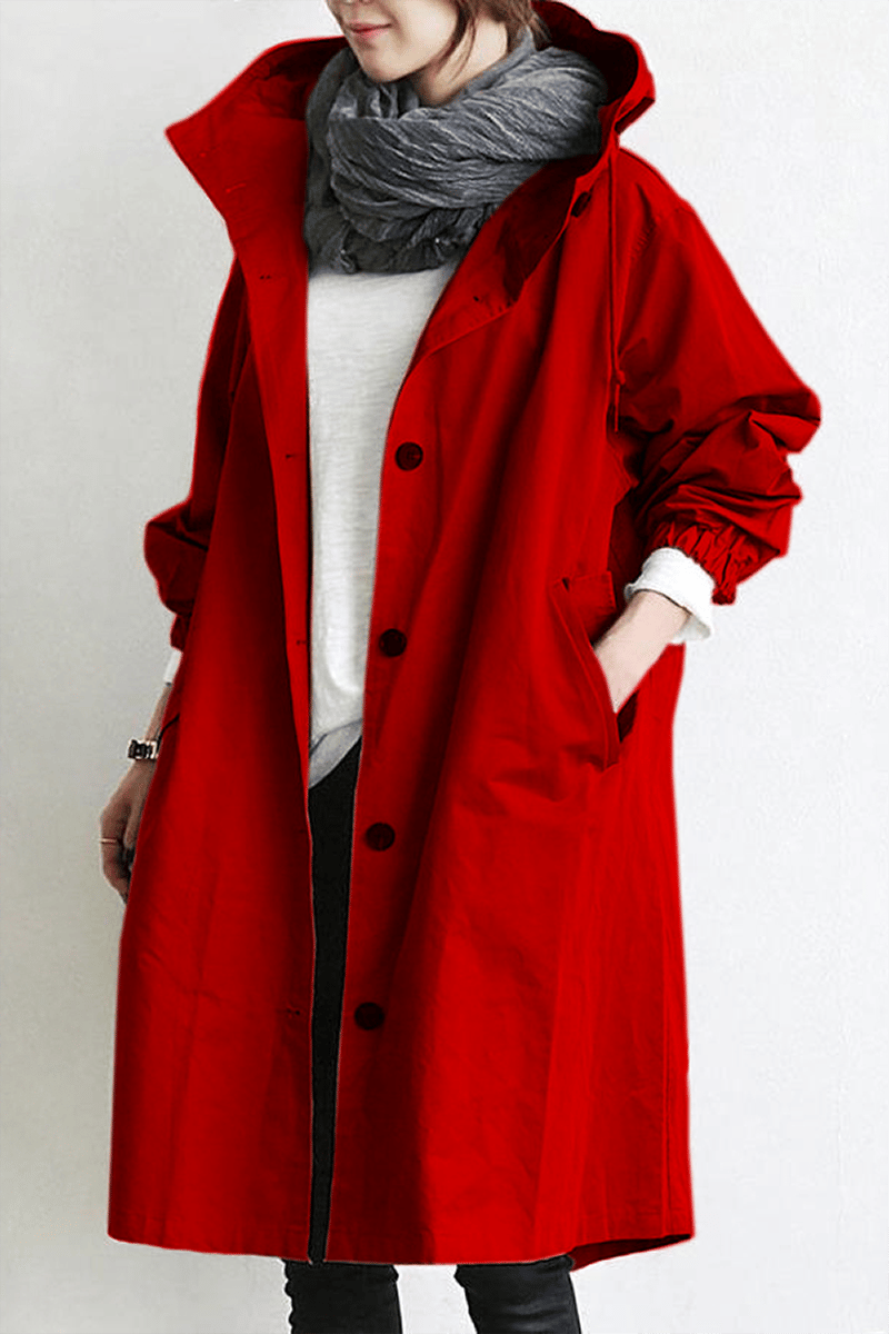 Red hooded button-up coat with elasticated cuffs and a hand in the pocket, worn with a grey scarf 6