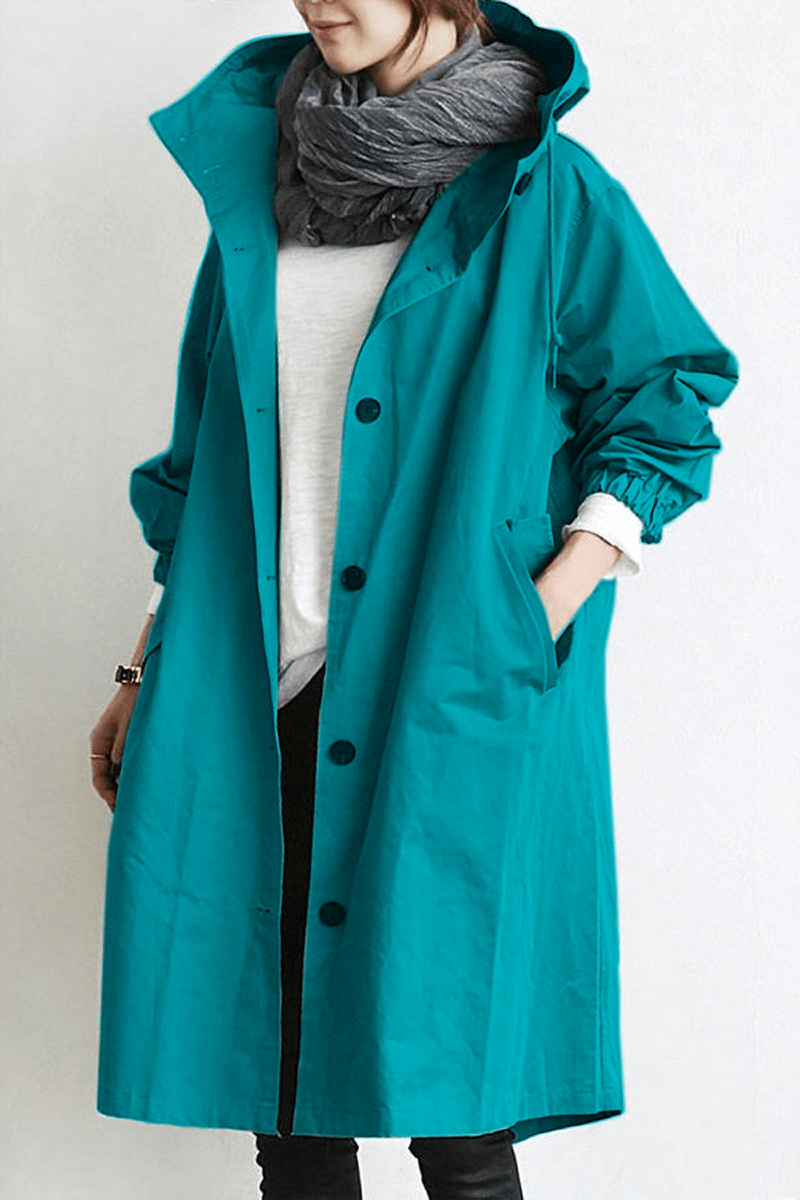 Teal hooded button-up coat with elasticated cuffs and front pockets, worn with a grey scarf 7