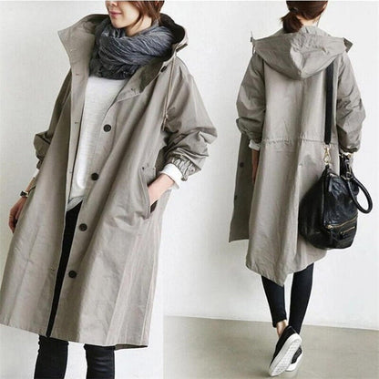 Front and back views of a light grey-beige hooded coat, with a black handbag on the shoulder 9