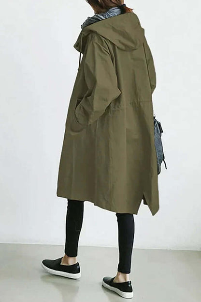 Back view of the olive green coat, showing the hood, gathered waist, side slit and slip-on shoes 9