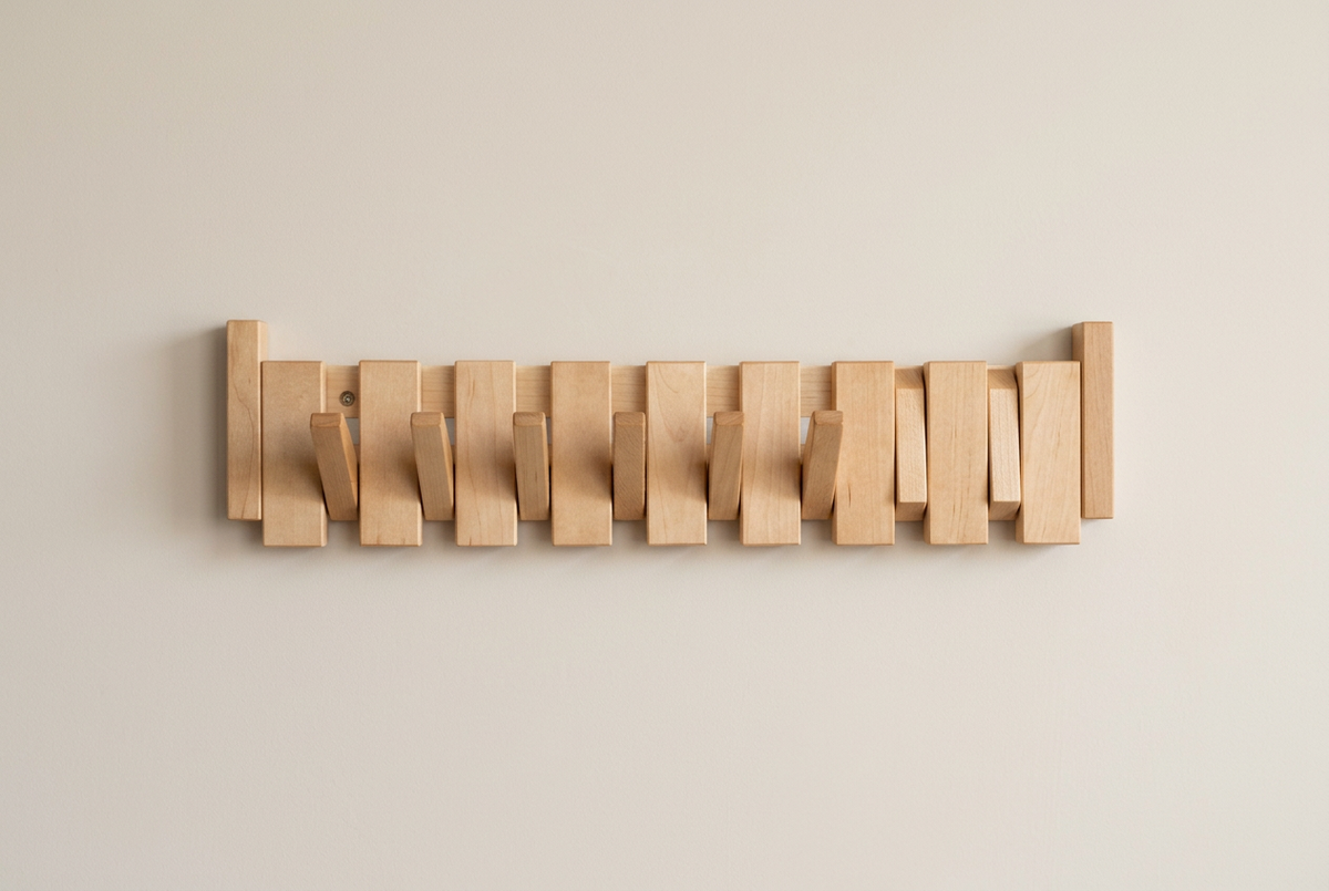 Pale maple-coloured rack with several hooks folded down against the slats on a beige wall 13