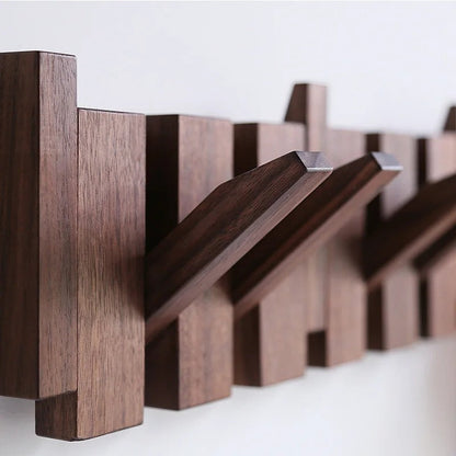 Close-up of dark wood grain on the rack, with several hooks folded out at an angle 7