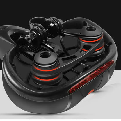 Underside of the saddle showing the clamp, twin shock-absorbing spring balls with red rings and the red reflector. 16