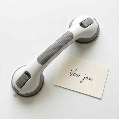 Flat lay of the white and grey grab bar lying on a white surface beside a small blank-style handwritten card. 19