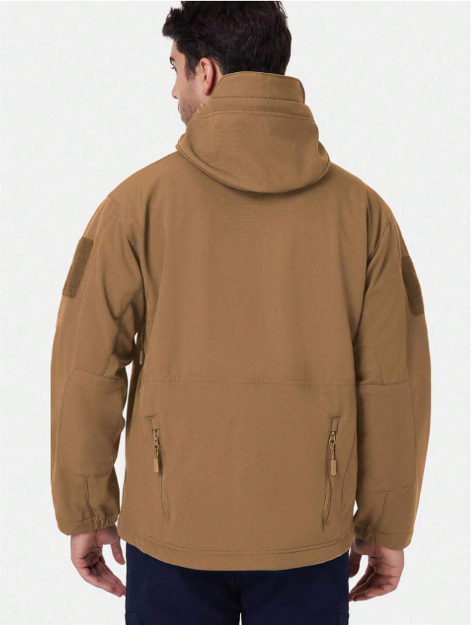 Back view of the tan hooded jacket on a model, with shoulder patches, lower zip pockets and elasticated cuffs. 14
