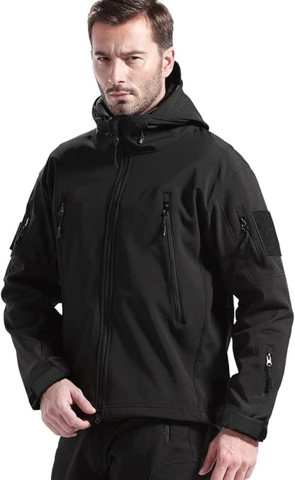 Man wearing the black hooded jacket, front view, showing the zipped chest pockets and sleeve pocket with hook-and-loop patch. 2