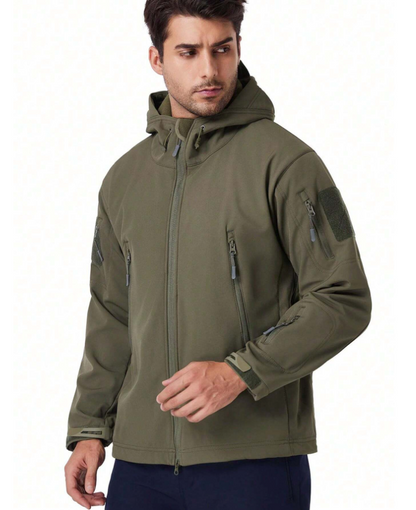 Man in the olive green hooded jacket, front three-quarter view, with zipped pockets and a patch panel on the sleeve. 4